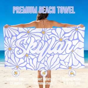 May include: A beach towel with a daisy pattern in white, light purple, and yellow. The towel has the name "Skylar" in large white letters. The text "PREMIUM BEACH TOWEL" is at the top.