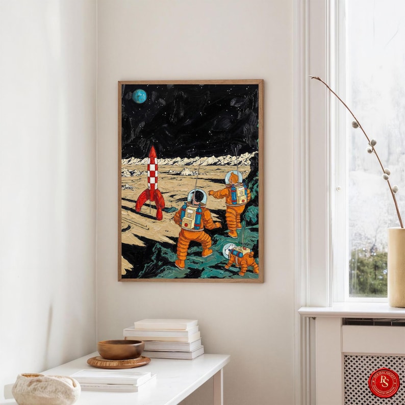 May include: A framed art print depicting a retro space scene. Two astronauts in orange suits explore a lunar landscape with a red and white rocket. A small dog in an orange suit accompanies them. A blue planet and a starry sky are in the background.
