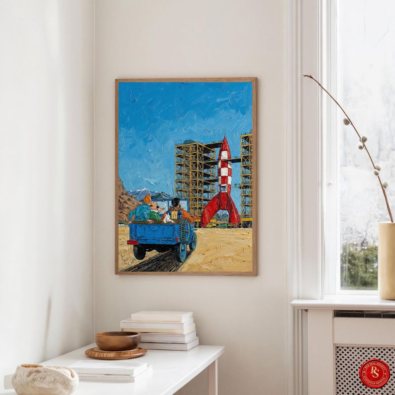 May include: A framed painting depicts a blue truck with passengers, driving towards a red and white rocket. The background features a blue sky, construction scaffolding, and a sandy landscape. The artwork has a textured, impressionistic style.