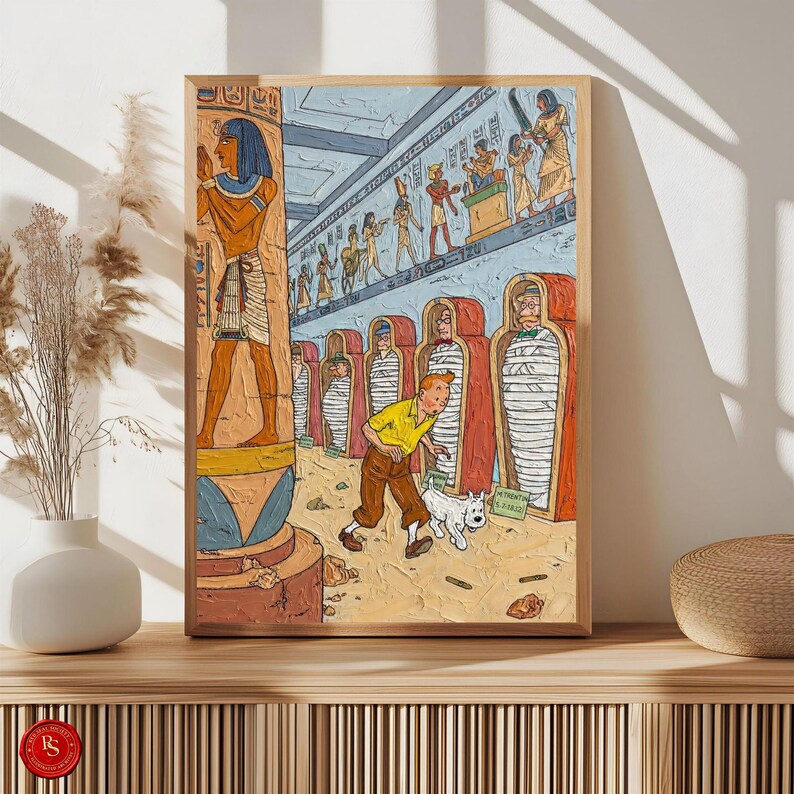 May include: A framed comic book illustration set in an Egyptian tomb. The artwork features a character in a yellow shirt and brown trousers, with a white dog. The scene includes mummies, hieroglyphs, and other Egyptian-themed details, all within a wooden frame.