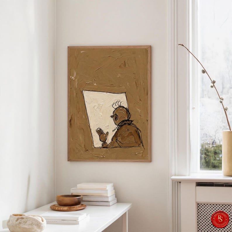 May include: Abstract painting featuring a figure with glasses looking at a white rectangle. The artwork is in a brown frame and has a textured, impasto style. The painting hangs on a white wall above a white table with books and a wooden bowl.