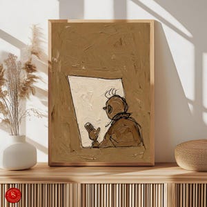 May include: A framed abstract art print featuring a figure reading a document. The artwork uses a palette of brown and cream tones, with a textured, painterly style. The figure is depicted in a simple, sketched style, adding a touch of whimsy to the piece.
