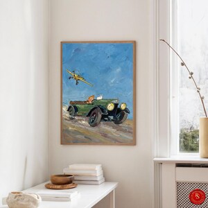 May include: A framed painting depicts a vintage green car with passengers and a yellow biplane in a blue sky. The artwork has a textured, impressionistic style, with visible brushstrokes. The car has large headlights and black tires.