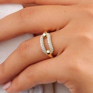 May include: A trio of ceramic mugs with a speckled, matte finish in cream, light grey, and dark grey. Each mug features a simple, minimalist design, ideal for tea or coffee.