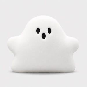 May include: A plush ghost-shaped pillow with a soft white fabric surface. The ghost features two small, round black embroidered eyes and a single oval-shaped black embroidered mouth, creating a simple, symmetrical, and rounded character design.