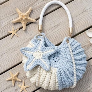 May include: A round crochet handbag featuring a two-tone light blue and cream ribbed pattern, a white braided handle, a matching crochet starfish charm, and a delicate white pearl bead strap, accompanied by several natural starfish.