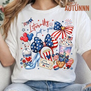 May include: White t-shirt with a patriotic design featuring a bow, popcorn, high heel, and a drink. The shirt has the text "Literally just a girl" and includes red, white, and blue elements.