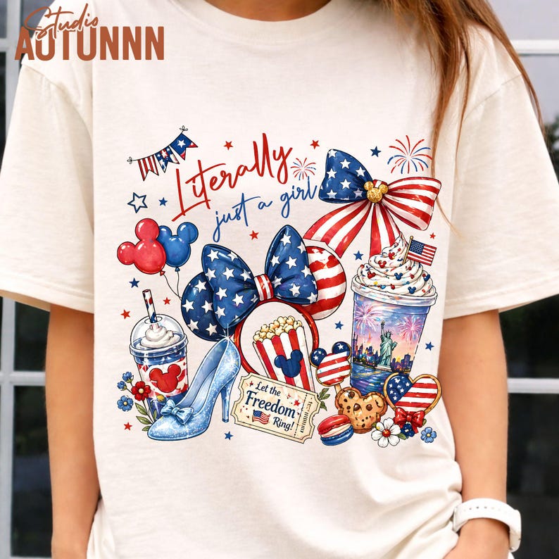 May include: Cream-colored t-shirt featuring a patriotic design with the text "Literally just a girl." The design includes a bow, Mickey Mouse balloons, a high heel, popcorn, and a beverage, all in red, white, and blue.