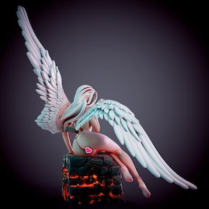 May include: A figurine of a figure with long white hair and large white feathered wings, seated on a dark, textured block with glowing orange cracks. The figure has a small pink heart icon placed on the lower back area, visible from behind.