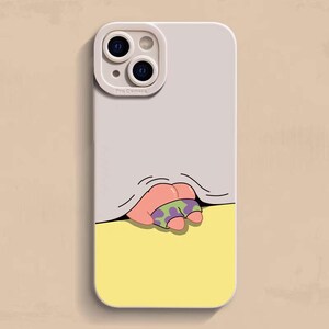 May include: A phone case with a light gray top and a yellow bottom. The case features a cartoon illustration of a mouth and fingers wearing camouflage shorts. The phone case has a camera bump.