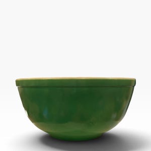 May include: A solid green bowl with a smooth, rounded exterior and a slightly flared rim. The bowl features a consistent, vibrant green finish across its entire outer surface, showcasing a simple, functional design with a deep, curved basin.
