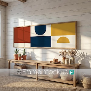 May include: A rectangular wall art piece in a wooden frame featuring a geometric design with blocks of terracotta, navy blue, and mustard yellow on a cream background. The artwork is displayed above a wooden console table with baskets and plants.