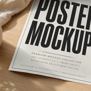 May include: A white paper poster mockup featuring bold black text that reads POSTER MOCKUP. Below this, smaller text lists features including PREMIUM MOCKUP COLLECTION, PSD LAYERED FILE, SMART OBJECT, BRIGHTNESS ADJUSTMENT OPTION, EASY TO USE, HIGH RESOLUTION, and PROFESSIONAL RESULTS.