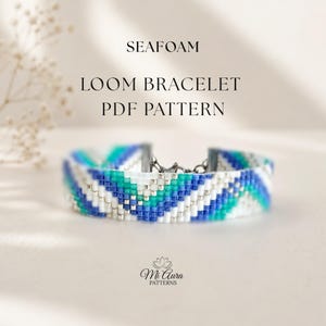 May include: A beaded loom bracelet featuring a chevron pattern in shades of blue, teal, and white with silver accents. The text SEAFOAM LOOM BRACELET PDF PATTERN and the Mi Aura Patterns logo are visible above and below the bracelet.