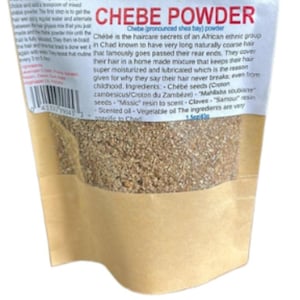 May include: A bag of Chebe powder, a haircare product from an African ethnic group. The bag is tan with a white label that has text in red and black. The powder is a light brown color and appears to be a fine grain.