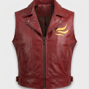May include: A deep red leather vest featuring a notched lapel collar, a central metal zipper closure, and adjustable side buckle straps at the hem. A yellow flame-like graphic is printed on the left chest area, and the interior is lined.