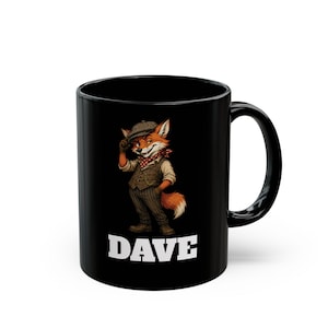 May include: A black ceramic mug featuring a graphic of a fox wearing a flat cap, waistcoat, and neckerchief, standing with one hand on its hat. The name DAVE is printed in bold white capital letters underneath the fox illustration on the mug.