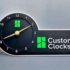 May include: A black wall clock with a white border, featuring a circular face with white numbers 1 through 12, gold hands, and a bright green logo. To the right, a rectangular extension displays the same green logo and the text Custom Clocks.