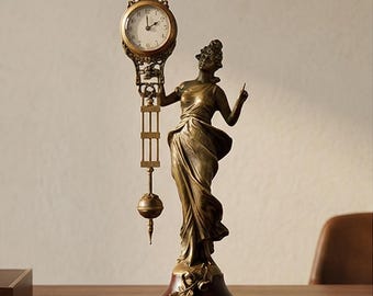A Table Clock Mysterious Helt By A Dressed Woman, 33cm High