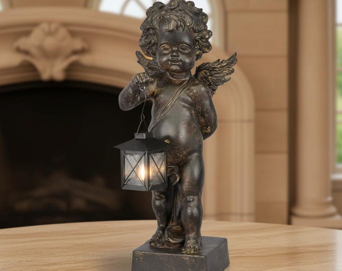 A Resin Figurine Of A Putto Holding A Lantern 46cm