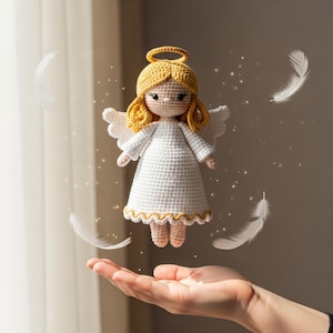 May include: A handmade crochet angel doll with a white dress, yellow hair, and a halo. The doll has white wings and is surrounded by white feathers. The doll is approximately 6 inches tall.