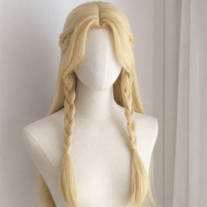 May include: A long, light blonde wig styled with a centre part and two symmetrical plaits framing the face. The hair is straight and falls past the shoulders, featuring a braided crown detail that connects to the two front-facing plaits.