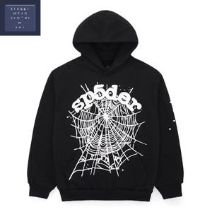 May include: Black hooded sweatshirt with a white spider web design and the word "sp5der" in a stylized font. The sweatshirt has a front pocket and a drawstring hood. The sleeves have small star graphics.