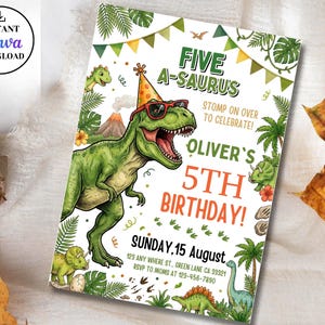 May include: A birthday invitation card featuring a green T-Rex wearing a party hat and sunglasses, surrounded by jungle foliage, a volcano, and smaller dinosaurs. The text reads FIVE A-SAURUS, STOMP ON OVER TO CELEBRATE, OLIVER'S 5TH BIRTHDAY, SUNDAY, 15 AUGUST.