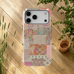 May include: A rectangular smartphone case featuring a multi-patterned patchwork design. The surface displays various floral, geometric, and botanical prints in soft shades of pink, orange, blue, and cream, including a small horse illustration.