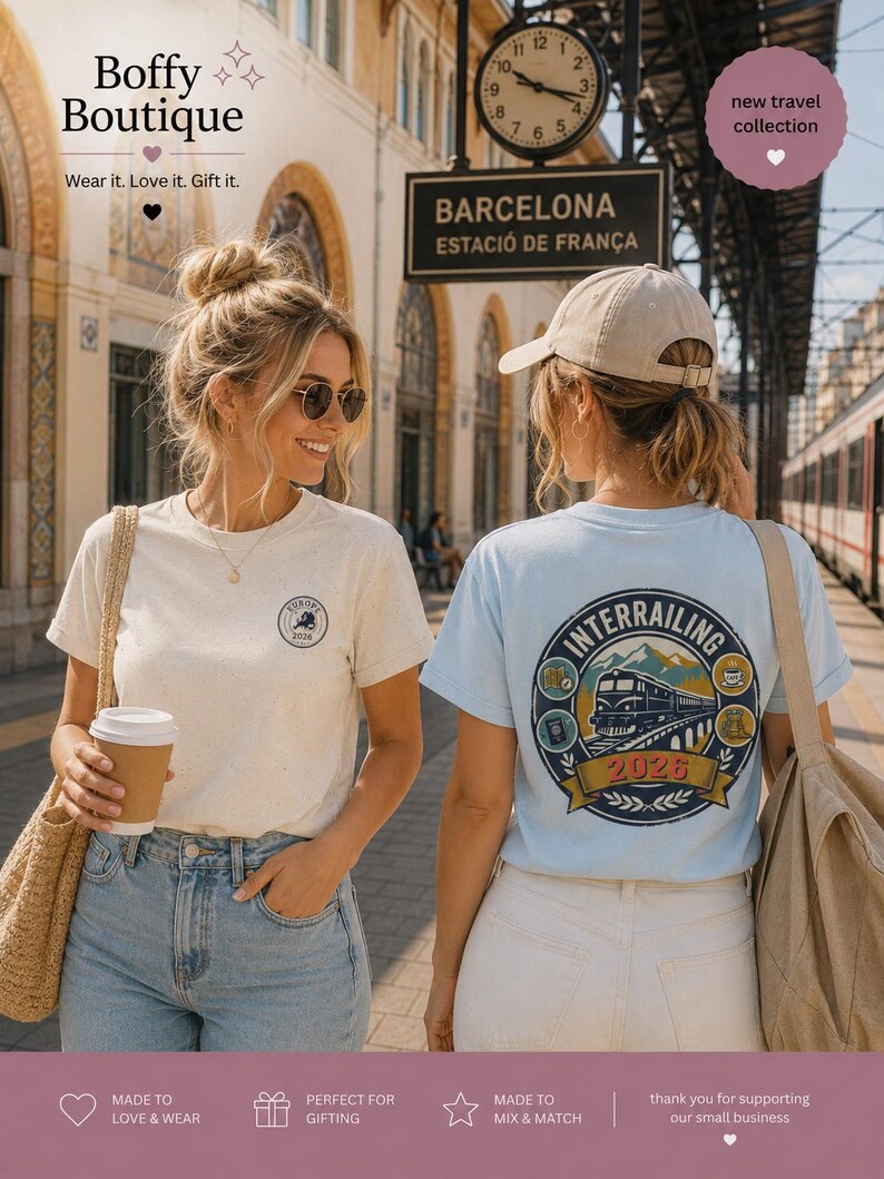 May include: A cream-colored t-shirt with a small circular Europe 2026 logo on the chest and a light blue t-shirt with a large circular Interrailing 2026 graphic on the back featuring a train, mountains, and travel icons.
