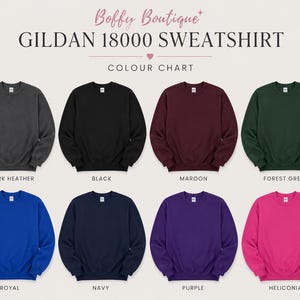 May include: A color chart displays eight Gildan 18000 sweatshirts in various colors. The colors include dark heather, black, maroon, forest green, royal, navy, purple, and heliconia. The text "Boffy Boutique" and "GILDAN 18000 SWEATSHIRT" are at the top.