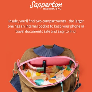 May include: A brown walking bag with a blue strap and a pink zipper. The bag has two compartments, one with an internal pocket. The bag has the text "Sapperton WALKING BAG" on the top. The interior has a colorful floral pattern.