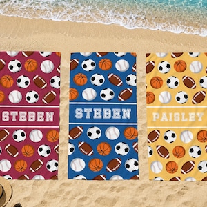 May include: Three rectangular beach towels featuring a repeating pattern of soccer balls, basketballs, baseballs, and footballs. The left towel is maroon with the name STEBEN, the center is blue with STEBEN, and the right is yellow with PAISLEY.