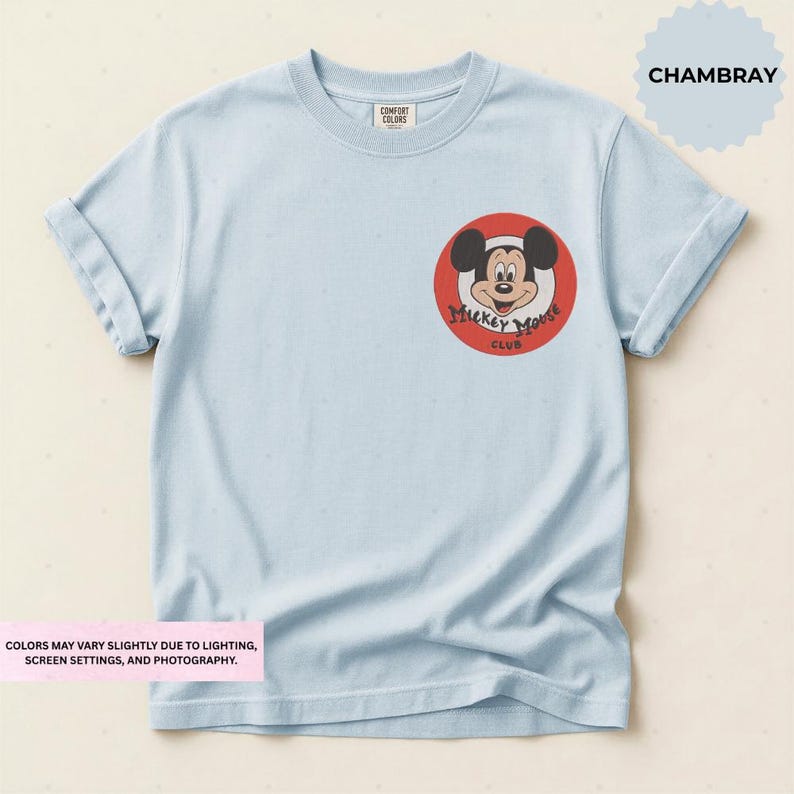 A light blue t-shirt with a red and white Mickey Mouse logo on the front.