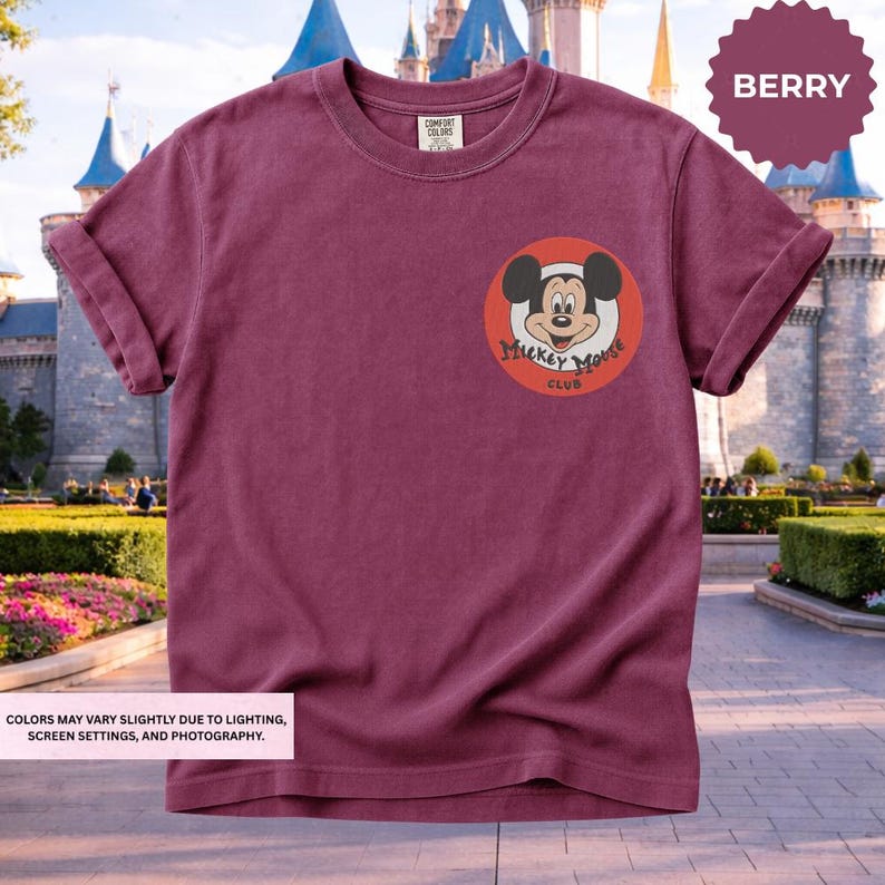 A maroon t-shirt with a Mickey Mouse logo and the text "Mickey Mouse Club" displayed on the front pocket area.