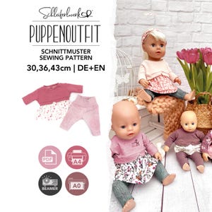 May include: A sewing pattern for doll outfits labeled Schleiferwerk PUPPEN OUTFIT SCHNITTMUSTER SEWING PATTERN 30, 36, 43cm | DE+EN. The image displays doll clothing sets including long-sleeved tops and pants, alongside three dolls wearing similar outfits.