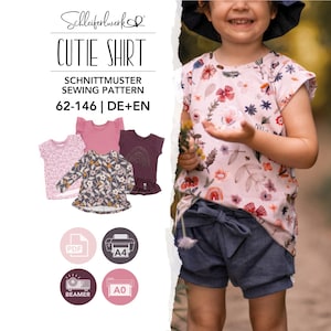 May include: A sewing pattern for a shirt titled Cutie Shirt by Schleiferwerk. The pattern includes sizes 62-146 in German and English. It features illustrations of various shirt styles with floral and solid designs, plus PDF, A4, and A0 icons.