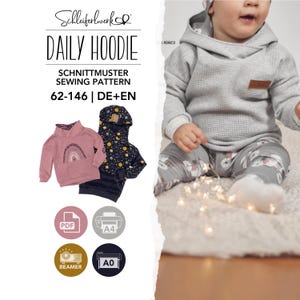 May include: A sewing pattern for a daily hoodie labelled 62-146 DE+EN by Schleiferwerk. The image displays a grey waffle-knit hoodie, a pink hoodie with a rainbow graphic, and a dark blue hoodie with a celestial print, alongside PDF, A4, A0, and beamer icons.