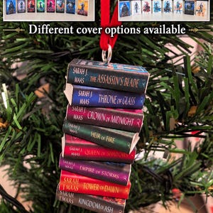 May include: A miniature book ornament featuring a stack of eight Sarah J. Maas novels including The Assassin's Blade, Throne of Glass, Crown of Midnight, Heir of Fire, Queen of Shadows, Empire of Storms, Tower of Dawn, and Kingdom of Ash.
