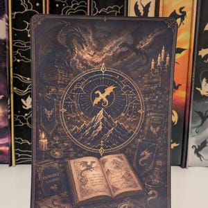 May include: A rectangular metal print featuring a dark, intricate illustration of a dragon perched on a stone structure above a mountain range. An open book, a candle, and banners are depicted below, with the text "KNOWLEDGE IS POWER" on a book cover.