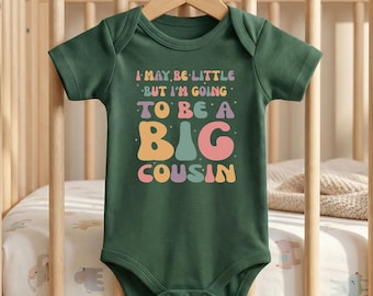 I May Be Little But I’m Going To Be A Big Cousin Baby Bodysuit