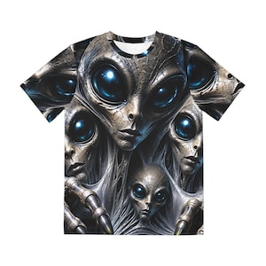 May include: A short-sleeved t-shirt featuring an all-over graphic print of multiple extraterrestrial beings with large, dark, reflective blue eyes and textured, metallic-toned skin. The design includes web-like structures and clawed hands.