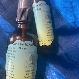 May include: Two amber glass bottles with spray and roll-on applicators. The spray bottle has a label that reads "Don't be TICKed Spray" and lists essential oils. The roll-on bottle is labeled "Don't be TICKed Roll on".
