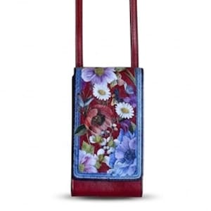 May include: A burgundy leather crossbody bag with a floral print. The bag features a rectangular shape with a flap closure and a long, thin strap. The floral design includes red, purple, and blue flowers against a red background.