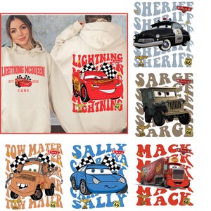 May include: Beige hoodie featuring Lightning McQueen from the Cars movie. The front displays the text "Lightning McQueen" and "Cars". The back shows a large image of Lightning McQueen with checkered flags and the text "Lightning". Additional designs include Sheriff, Sarge, Tow Mater, Sally, and Mack.