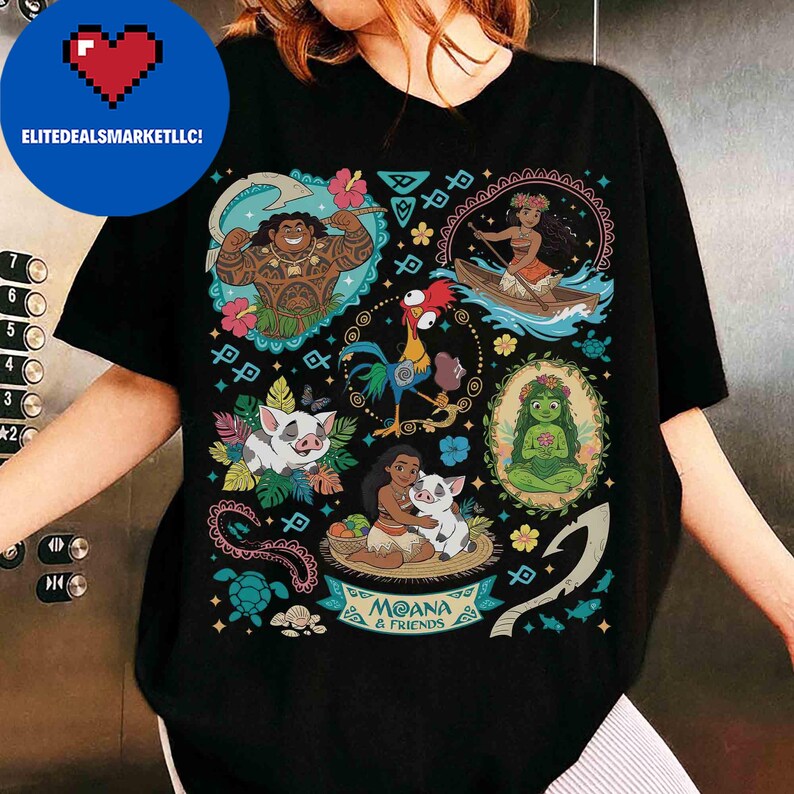 May include: Black t-shirt featuring colorful illustrations of characters from the animated film "Moana." The design includes images of Maui, Moana, Pua, Hei Hei, and other elements. The text "Moana & Friends" is also visible.