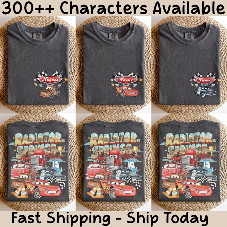 May include: A dark gray t-shirt featuring a small chest graphic of a race car with a checkered flag and the text Name, and a large back graphic depicting multiple race cars, a trophy, and the text Radiator Springs in a colorful design.