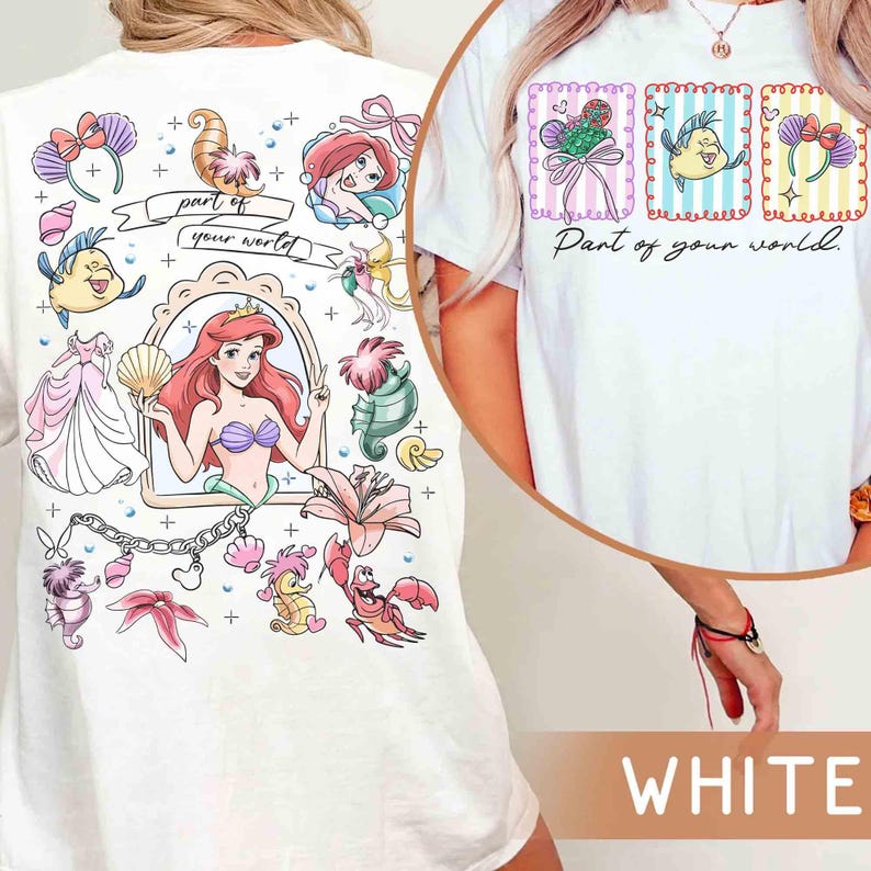 May include: White t-shirt featuring a colorful graphic of Ariel from The Little Mermaid. The design includes Ariel, Flounder, and other sea-themed elements. The text "part of your world" is also included in the design.