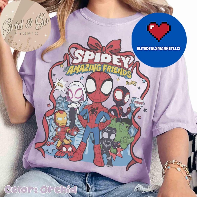 May include: Orchid-colored t-shirt featuring a graphic of Spidey and his Amazing Friends. The design includes Spider-Man, Spider-Gwen, Miles Morales, Iron Man, and the Hulk. The text "SPIDEY & AMAZING FRIENDS" is displayed in a ribbon.