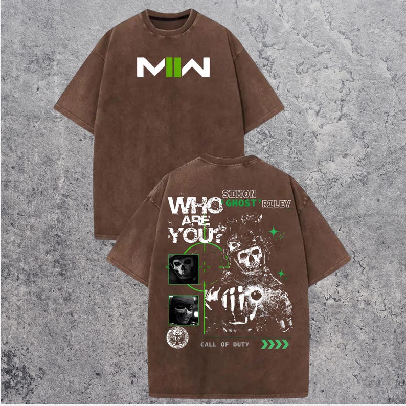May include: Brown t-shirt with the letters "MW" in white and green on the front. The back of the shirt features a graphic of a skull and the text "WHO ARE YOU?" and "CALL OF DUTY".